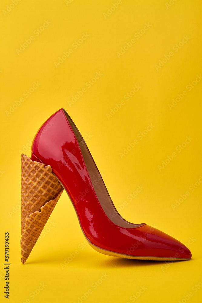 Shoe's high heel made of ice-cream cone. Peculiar and unusual footwear  design concept. Isolated on yellow background. Stock Photo | Adobe Stock