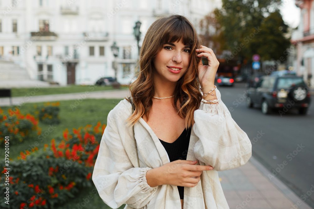 Beautiful sexy brunette girl in casual clothes with perfect figure walking around the city center. Elegant style. Beautiful sexy brunette girl in casual clothes with perfect figure walking around the city center. Elegant style.