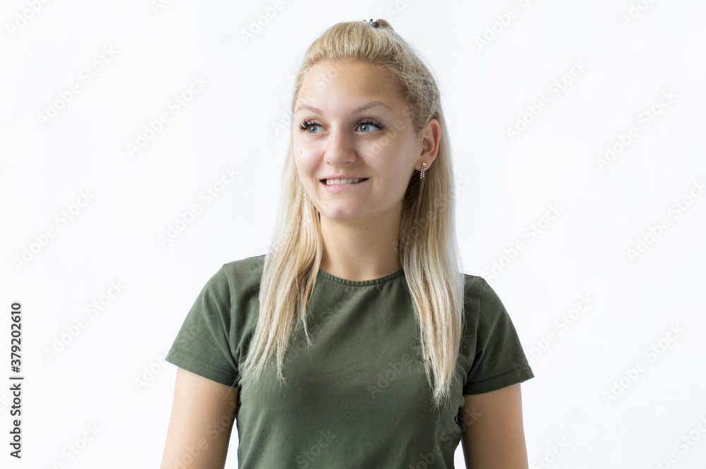 Beautiful Girl with Blond Hair looks at camera biting her lip, building plans, thinking about something, making decision. Face expression, feelings and attitude Beautiful Girl with Blond Hair looks at camera biting her lip, building plans, thinking about something, making decision. Face expression, feelings and attitude