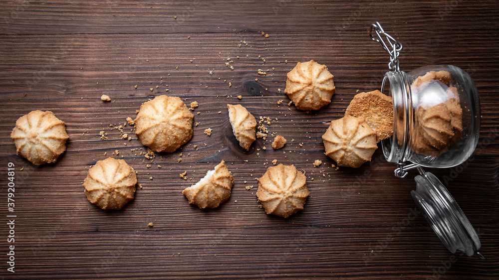 Fototapeta premium Cookies and glass jar on a wooden table