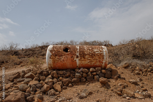 standing in the desert.abandoned metal fuel barrel in rust