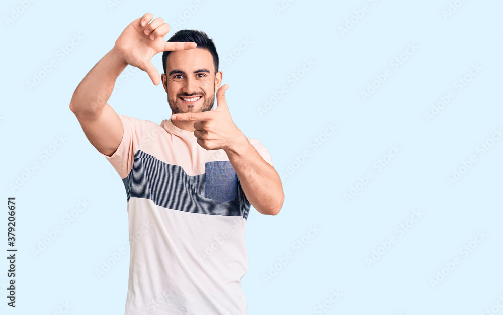 Young handsome man wearing casual clothes smiling making frame with hands and fingers with happy face. creativity and photography concept. Young handsome man wearing casual clothes smiling making frame with hands and fingers with happy face. creativity and photography concept.