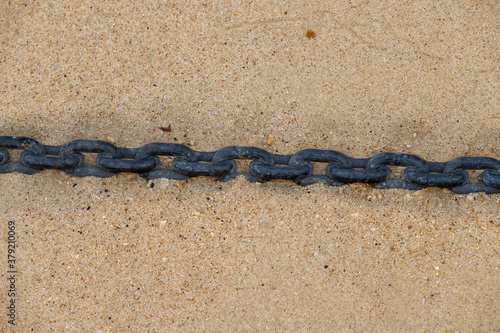 the chain stands under water in the sand