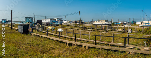 A panorama view towards boat houses in West Mersea, UK in the summertime
