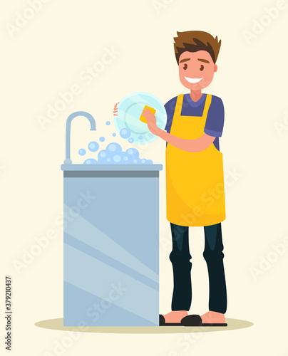 Smiling man dressed an apron is washing dish.