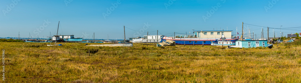 A panorama view across the salt marshes at West Mersea, UK in the summertime A panorama view across the salt marshes at West Mersea, UK in the summertime