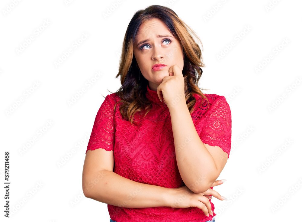 Young beautiful caucasian woman wearing casual clothes serious face thinking about question with hand on chin, thoughtful about confusing idea Young beautiful caucasian woman wearing casual clothes serious face thinking about question with hand on chin, thoughtful about confusing idea