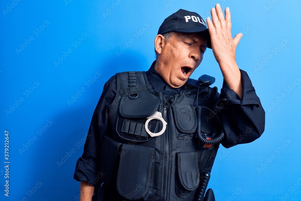 Senior man with grey hair wearing police uniform surprised with hand on head for mistake, remember error. forgot, bad memory concept. Senior man with grey hair wearing police uniform surprised with hand on head for mistake, remember error. forgot, bad memory concept.
