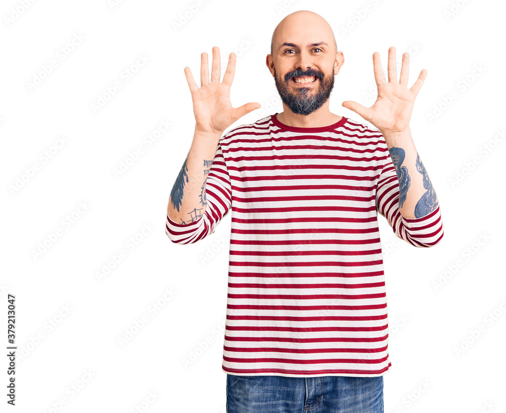 Young handsome man wearing casual clothes showing and pointing up with fingers number ten while smiling confident and happy. Young handsome man wearing casual clothes showing and pointing up with fingers number ten while smiling confident and happy.