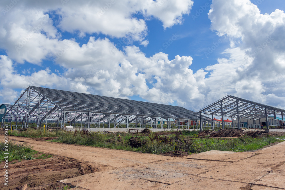 Steel frame of a building under construction. The construction of the building is made of steel beams. Construction of prefabricated structures Steel frame of a building under construction. The construction of the building is made of steel beams. Construction of prefabricated structures