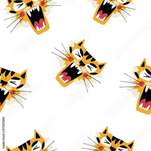 Cute muzzles of a roaring tiger seamless pattern for textile,fabric, coverage, wrapping paper and other print and design