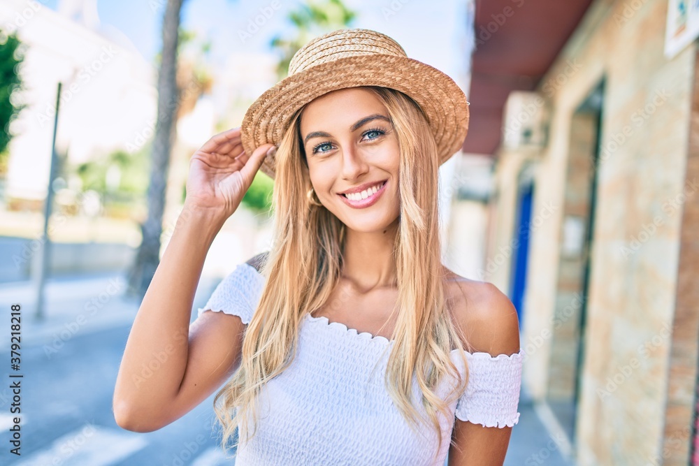 Young blonde tourist girl smiling happy walking at the city.