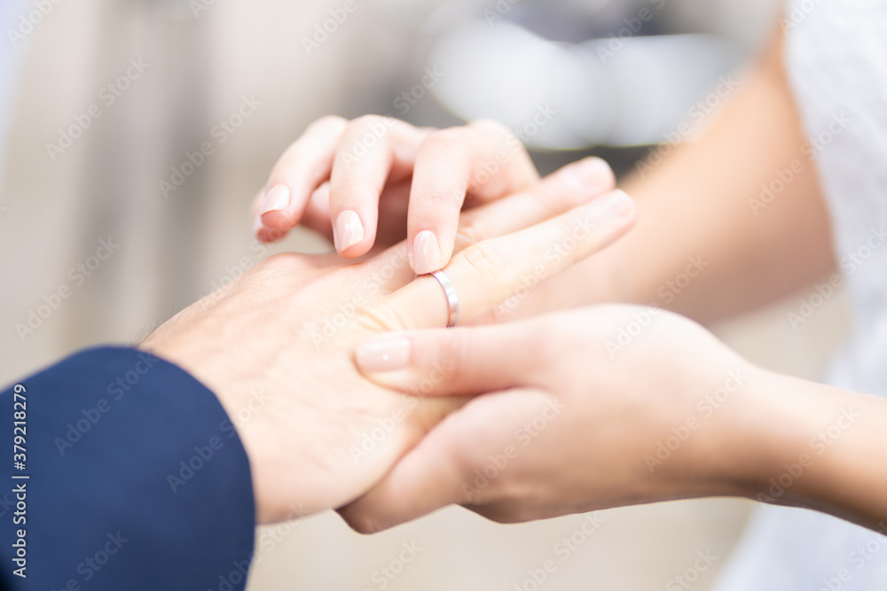 Ring Ceremony - Woman puts ring on husbands finger Ring Ceremony - Woman puts ring on husbands finger