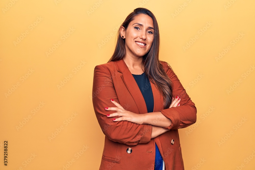 Fototapeta premium Young beautiful brunette woman wearing elegant jacket happy face smiling with crossed arms looking at the camera. positive person.