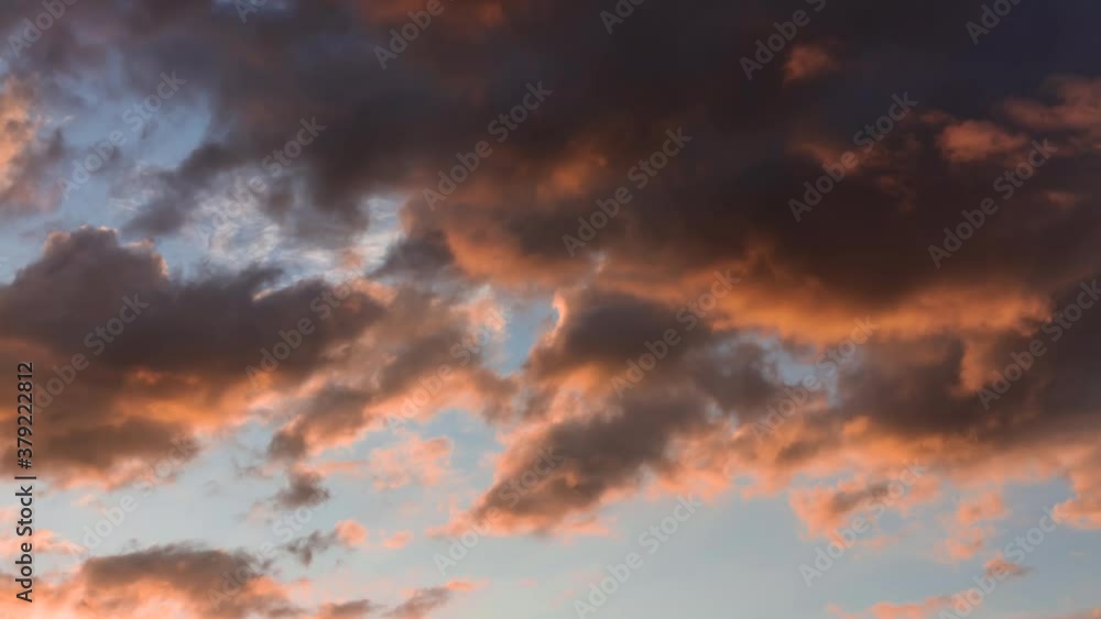 Time lapse. Sunset sky with huge rainy dark orange pastel cloud moving slowly on the horizon. Time lapse. Sunset sky with huge rainy dark orange pastel cloud moving slowly on the horizon.