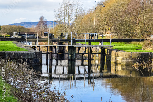 Lock 25 on the Forth & Clyde Canal, Maryhill Steps, Glasgow reflecting in water surface. photo