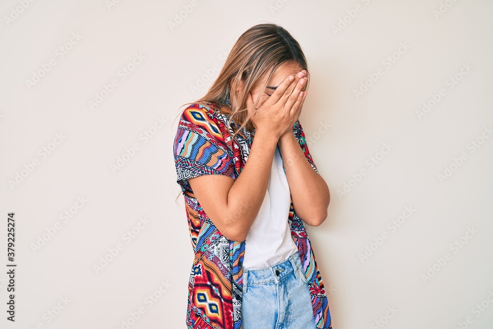 Young beautiful blonde woman wearing modern clothes with sad expression covering face with hands while crying. depression concept. Young beautiful blonde woman wearing modern clothes with sad expression covering face with hands while crying. depression concept.