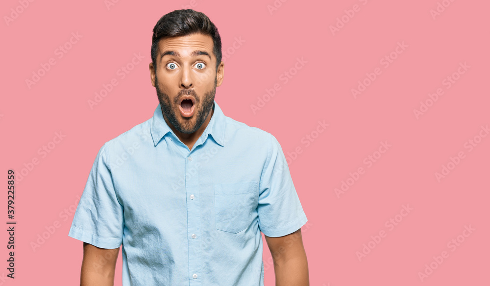 Handsome hispanic man wearing casual clothes afraid and shocked with surprise expression, fear and excited face. Handsome hispanic man wearing casual clothes afraid and shocked with surprise expression, fear and excited face.