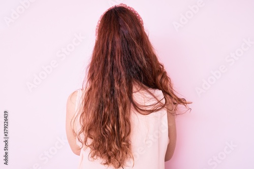 Young beautiful woman wearing casual clothes standing backwards looking away with crossed arms