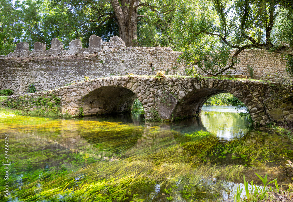 Garden of Ninfa and ruins of the medieval city Ninfa in Italy in the province of Latina. Most beautiful and romantic gardens in the world. Garden of Ninfa and ruins of the medieval city Ninfa in Italy in the province of Latina. Most beautiful and romantic gardens in the world.