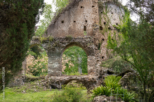 Garden of Ninfa and ruins of the medieval city Ninfa in Italy in the province of Latina. Most beautiful and romantic gardens in the world.
