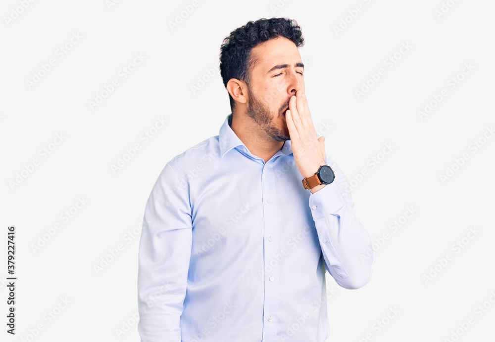 Young hispanic man wearing business clothes bored yawning tired covering mouth with hand. restless and sleepiness. Young hispanic man wearing business clothes bored yawning tired covering mouth with hand. restless and sleepiness.