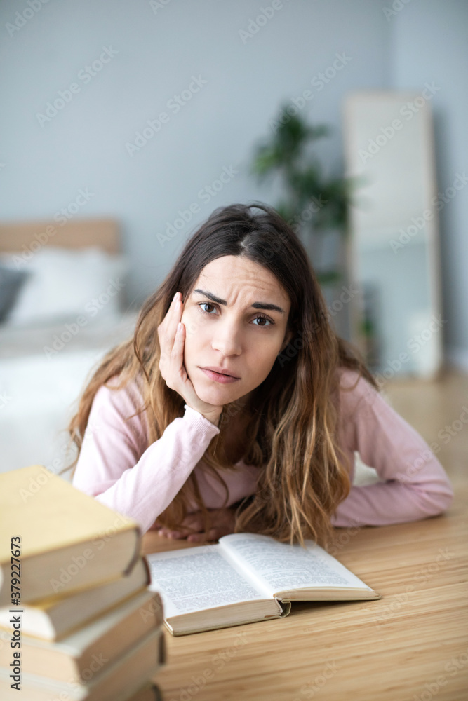 Young unhappy woman student with many books. Learning at home. Young unhappy woman student with many books. Learning at home.