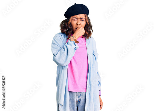 Young beautiful mixed race woman wearing french look with beret feeling unwell and coughing as symptom for cold or bronchitis. health care concept.