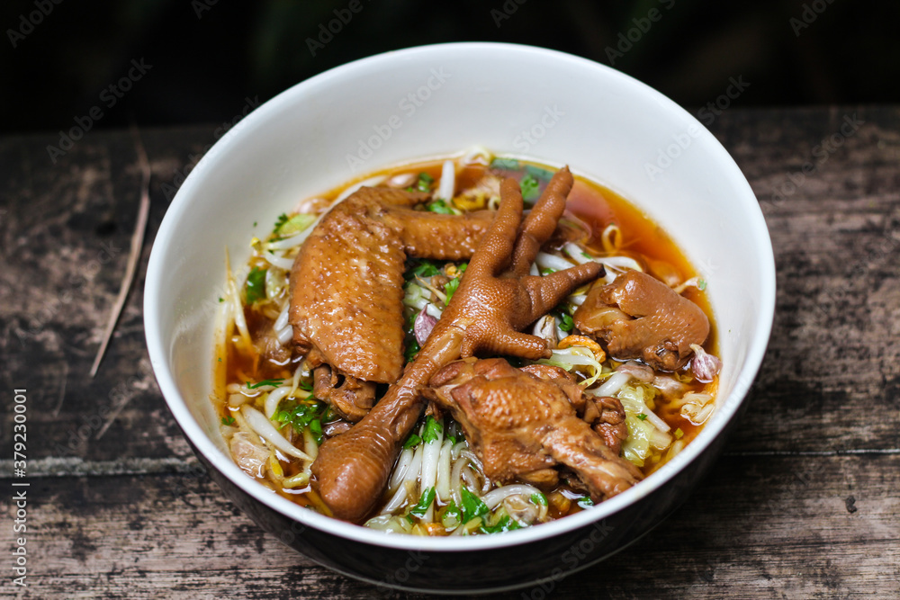 Thai street food noodles with braised chicken in a rich broth. Thai street food noodles with braised chicken in a rich broth.