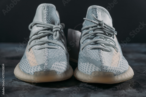 Fashionable lifestyle sneakers or pair of sport shoes on dark background  selective focus