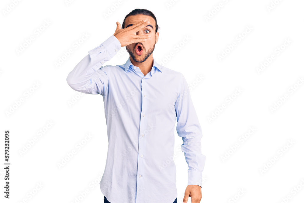 Young handsome man wearing business clothes peeking in shock covering face and eyes with hand, looking through fingers with embarrassed expression. Young handsome man wearing business clothes peeking in shock covering face and eyes with hand, looking through fingers with embarrassed expression.
