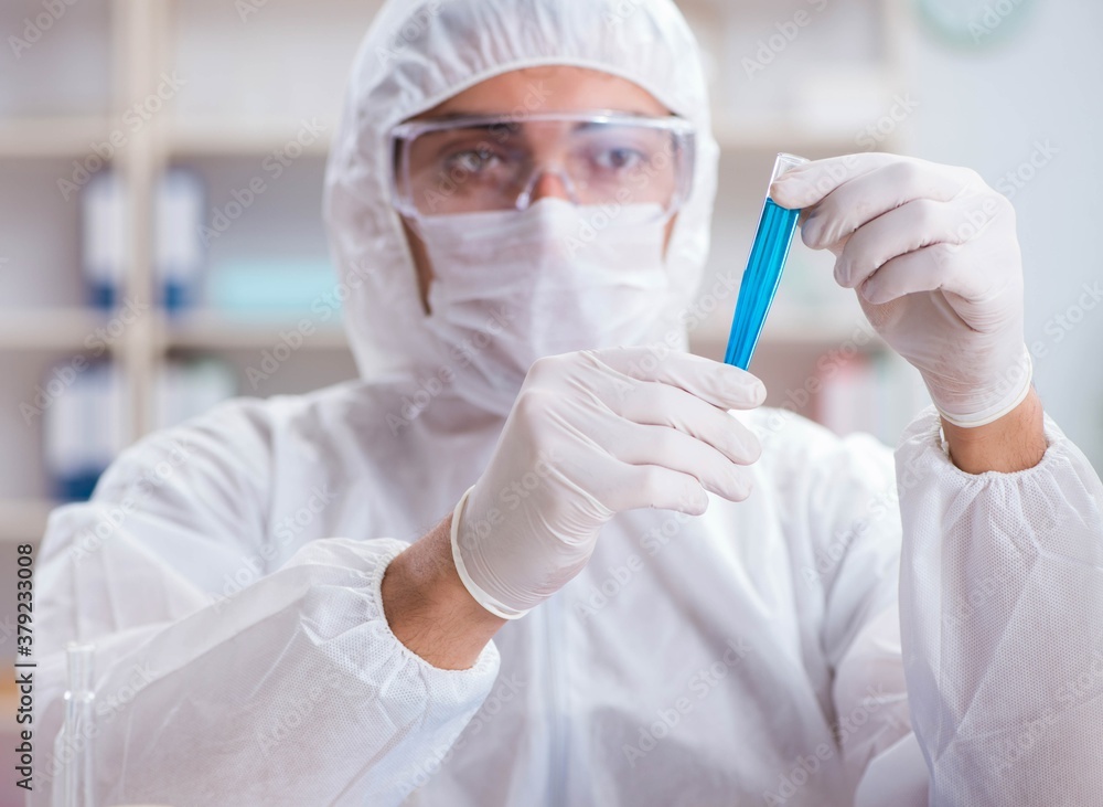 Young chemist student working in lab on chemicals Young chemist student working in lab on chemicals