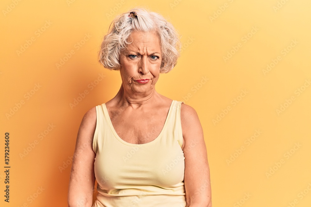 Senior grey-haired woman wearing casual clothes skeptic and nervous, frowning upset because of problem. negative person. Senior grey-haired woman wearing casual clothes skeptic and nervous, frowning upset because of problem. negative person.