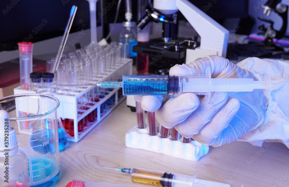 Scientist researching covid-19 vaccine in the laboratory. Scientist researching covid-19 vaccine in the laboratory.