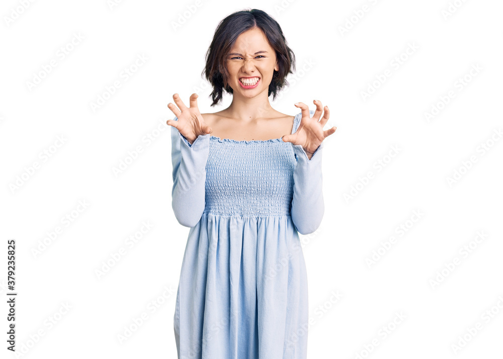 Young beautiful girl wearing casual clothes smiling funny doing claw gesture as cat, aggressive and sexy expression Young beautiful girl wearing casual clothes smiling funny doing claw gesture as cat, aggressive and sexy expression