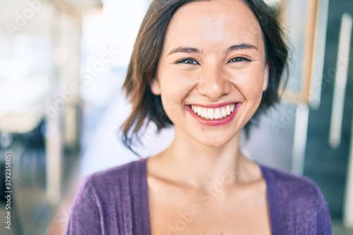 Young beautiful girl smiling happy walking at street of city