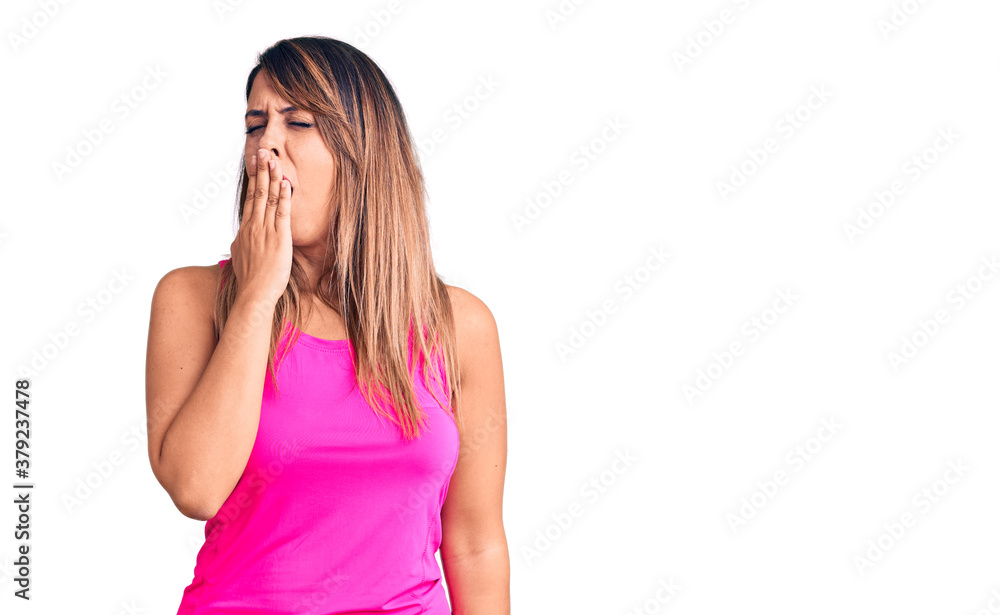 Young beautiful woman wearing sportswear bored yawning tired covering mouth with hand. restless and sleepiness. Young beautiful woman wearing sportswear bored yawning tired covering mouth with hand. restless and sleepiness.