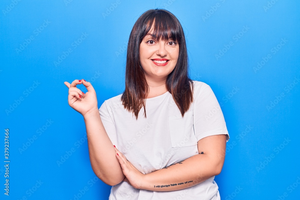 Young plus size woman wearing casual clothes smiling happy pointing with hand and finger to the side Young plus size woman wearing casual clothes smiling happy pointing with hand and finger to the side