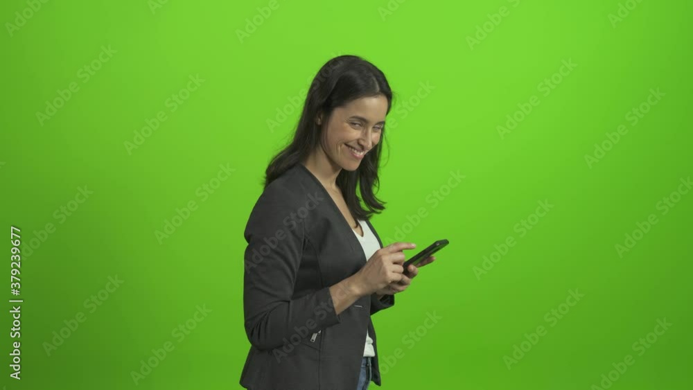 woman with mobile look at camera and smile on green screen chroma key
woman with mobile look at camera and smile on green screen chroma key