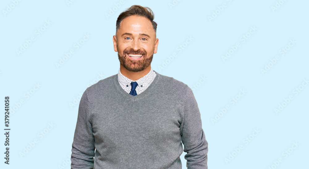 Handsome middle age man wearing business clothes with a happy and cool smile on face. lucky person. Handsome middle age man wearing business clothes with a happy and cool smile on face. lucky person.