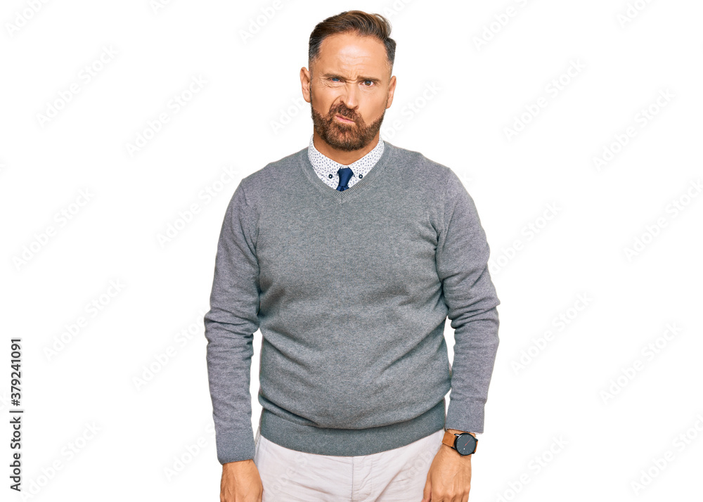 Handsome middle age man wearing business clothes skeptic and nervous, frowning upset because of problem. negative person. Handsome middle age man wearing business clothes skeptic and nervous, frowning upset because of problem. negative person.
