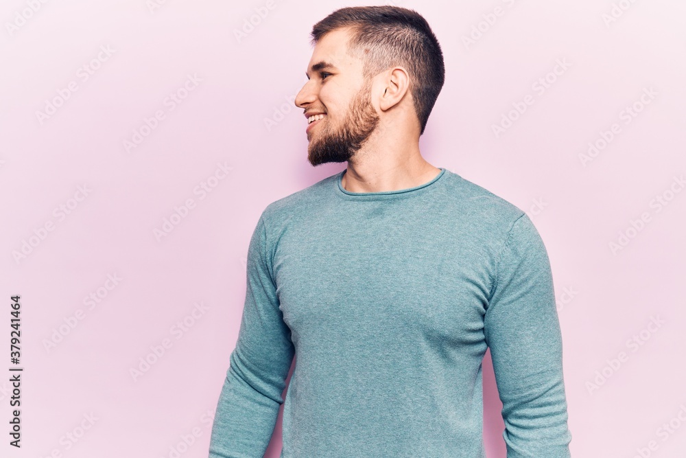 Young handsome man wearing casual sweater looking to side, relax profile pose with natural face and confident smile. Young handsome man wearing casual sweater looking to side, relax profile pose with natural face and confident smile.