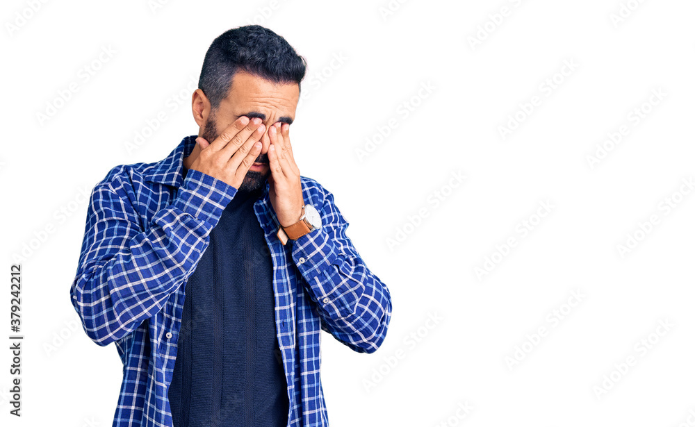 Young hispanic man wearing casual clothes rubbing eyes for fatigue and headache, sleepy and tired expression. vision problem Young hispanic man wearing casual clothes rubbing eyes for fatigue and headache, sleepy and tired expression. vision problem