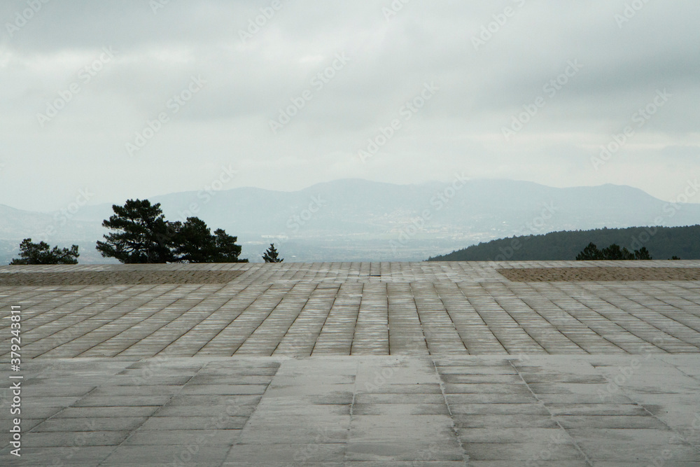 Architecture. Panorama view of the concrete wet esplanade made of blocks under a rainy sky. 
