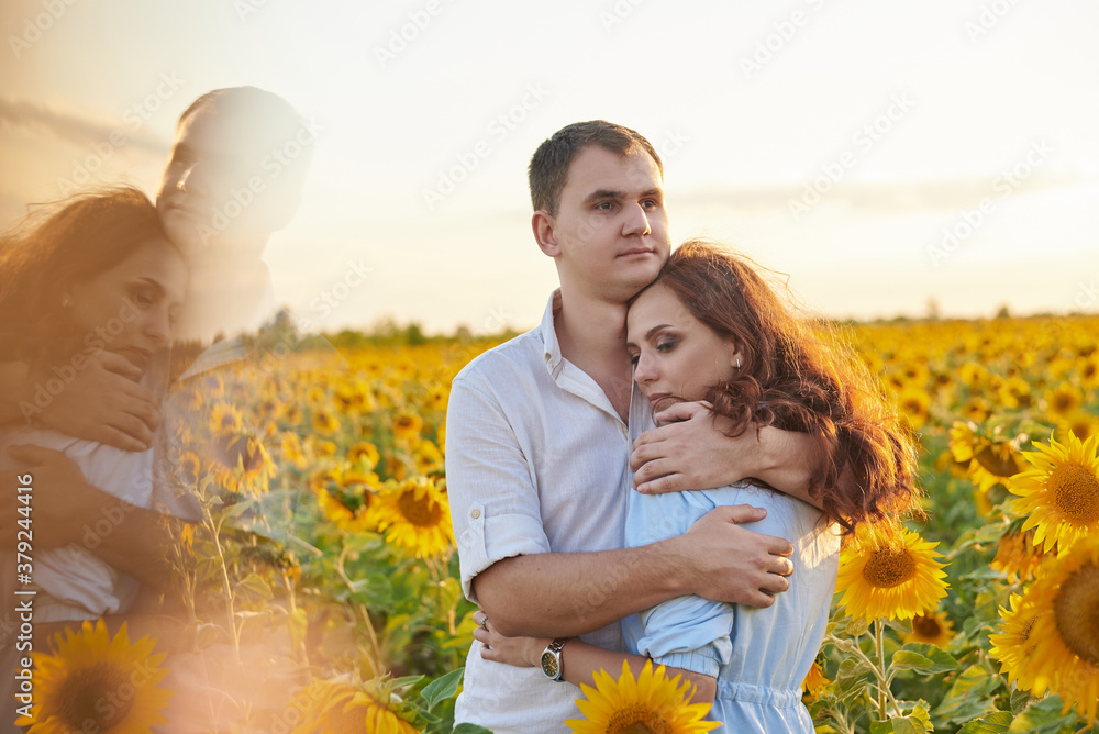 Smiling happy newlywed couple in a field of sunflowers. The concept of love, mutual respect and right relationships Smiling happy newlywed couple in a field of sunflowers. The concept of love, mutual respect and right relationships