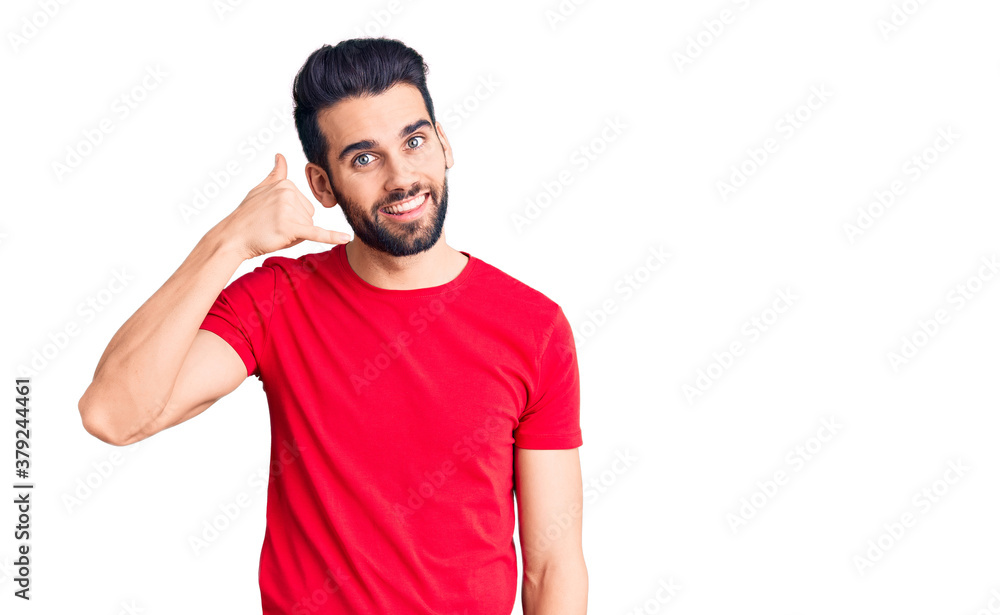 Young handsome man with beard wearing casual t-shirt smiling doing phone gesture with hand and fingers like talking on the telephone. communicating concepts. Young handsome man with beard wearing casual t-shirt smiling doing phone gesture with hand and fingers like talking on the telephone. communicating concepts.