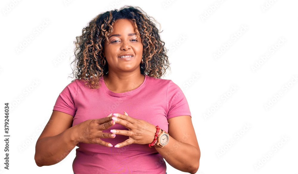 Young african american plus size woman wearing casual clothes hands together and fingers crossed smiling relaxed and cheerful. success and optimistic Young african american plus size woman wearing casual clothes hands together and fingers crossed smiling relaxed and cheerful. success and optimistic