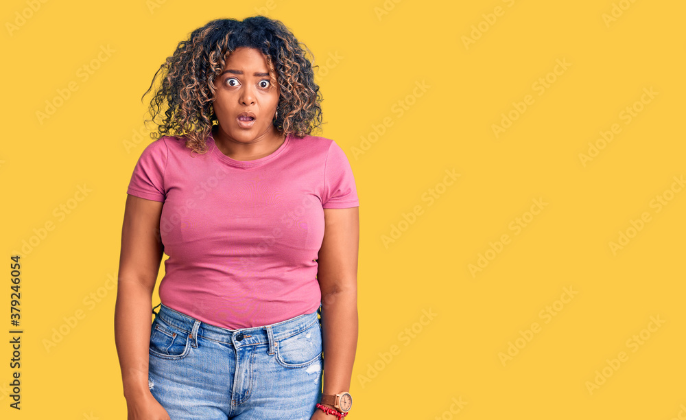 Young african american plus size woman wearing casual clothes in shock face, looking skeptical and sarcastic, surprised with open mouth Young african american plus size woman wearing casual clothes in shock face, looking skeptical and sarcastic, surprised with open mouth