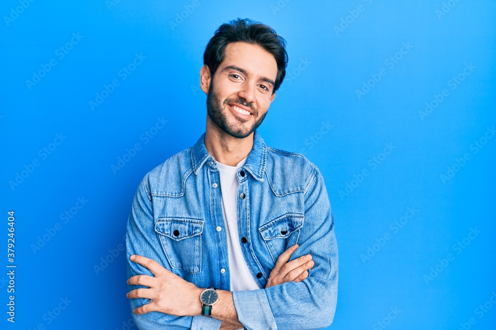 Young hispanic man wearing casual clothes happy face smiling with crossed arms looking at the camera. positive person. Young hispanic man wearing casual clothes happy face smiling with crossed arms looking at the camera. positive person.