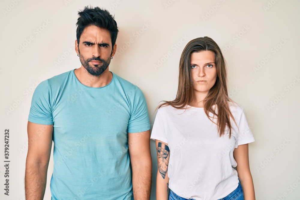 Beautiful young couple of boyfriend and girlfriend together skeptic and nervous, frowning upset because of problem. negative person. Beautiful young couple of boyfriend and girlfriend together skeptic and nervous, frowning upset because of problem. negative person.